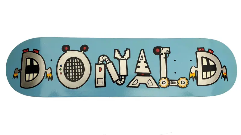 Skateboard painted with rattle cans with text reading 'Donald'