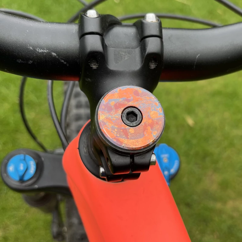 Custom cap on a bike stem, orange and black
